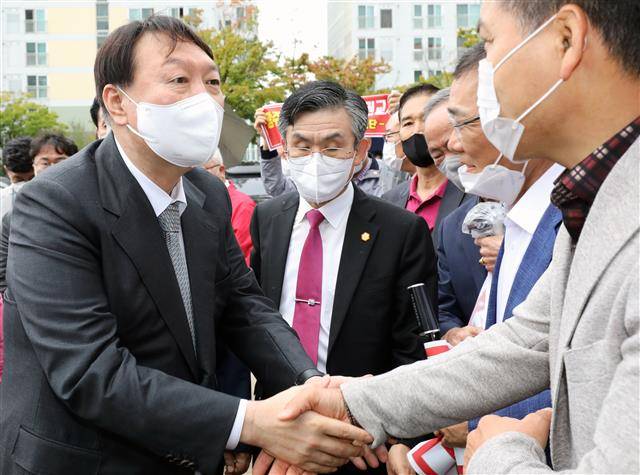 “어대윤” 외치는 지지자들과 인사하는 윤석열 - 윤석열 국민의힘 대선 경선 후보가 11일 오전 광주 서구 치평동 김대중컨벤션센터에서 열린 국민의힘 광주 최고위원회의에 입장하며 지지자들과 인사하고 있다. 2021.10.11 뉴스1