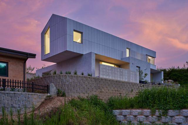 경기 양평에 위치한 단독주택 '흔연재'는 멀리서 보면 건물이 마치 공중에 떠 있는 듯하다. 독특한 외관 덕에 마을 어귀부터 눈길을 사로잡는다. 정갈한 돌이 떠 있는 듯한 이미지를 주고자 1층은 흙의 거친 질감을 가진 '스토', 2층은 화강석으로 마감재의 재료를 달리했다. 노경 건축사진작가 제공