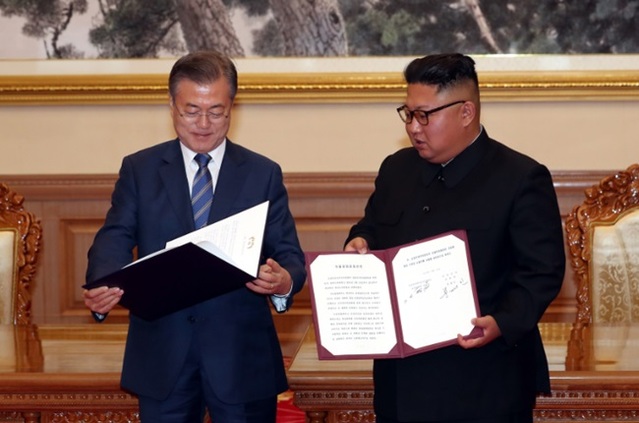 문재인 대통령과 김정은 북한 국무위원장이 2018년 9월 19일 백화원 영빈관에서 정상회담을 마친 뒤 평양공동선언서에 서명하고있다. 청와대 제공