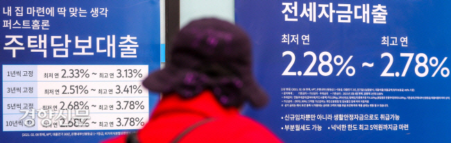 한 시민이 지난해 서울 시내의 한 시중은행 외벽에 붙어있는 대출 금리 안내판 앞을 지나가고 있다. 경향신문 자료사진