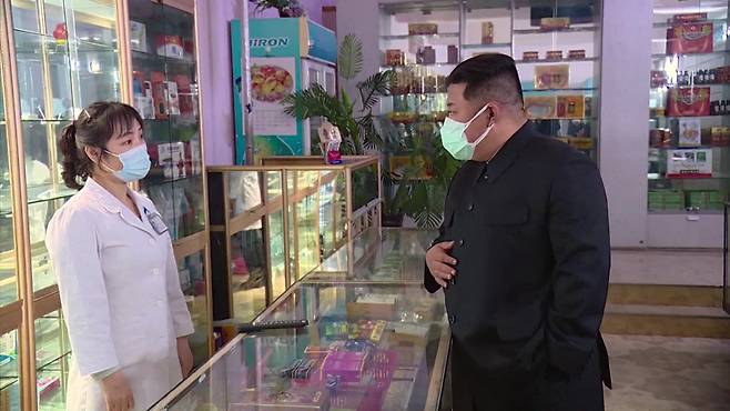 In this footage released Monday by the Korean Central Television, North Korean leader Kim Jong-un was seen wearing a blue surgical mask on top of a white mask of an unknown material. (Yonhap)