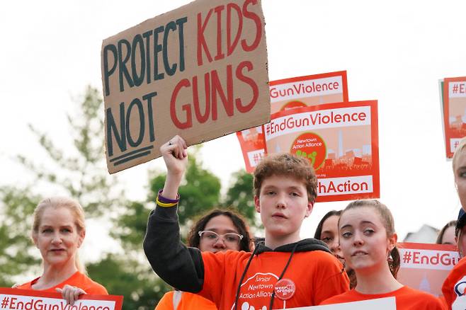 10년 전 미국 역사상 최악의 학교 내 총기 참사가 벌어졌던 샌디훅 초등학교가 있는 미국 코네티컷주 쥬타운의 청소년과 학부모들이 총기 폭력 경각심의 날인 3일(현지시간) 총기 폭력 근절을 뜻하는 오렌지색 옷을 맞춰 입고 총기 규제를 요구하는 시위를 하고 있다. 뉴타운|로이터연합뉴스