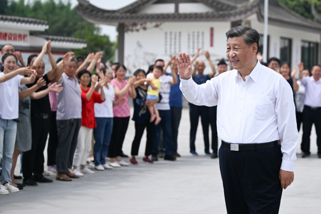 시진핑 중국 국가주석이 8일 쓰촨성 메이산의 융펑 마을을 방문해 주민들에게 손을 흔들고 있다. 연합뉴스.