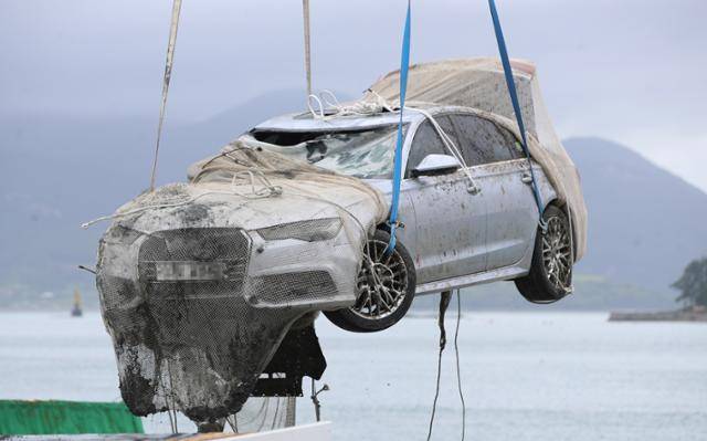 29일 오전 전남 완도군 송곡선착장 인근 방파제에서 경찰이 10m 바닷속에 잠겨 있던 조유나(10)양 가족의 차량을 인양한 뒤 조사를 위해 지상으로 옮기고 있다. 완도=연합뉴스
