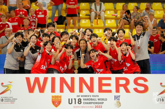 The Korean team celebrates after beating Denmark to win the International Handball Federation's Women's Youth World Championship in Skopje, North Macedonia on Wednesday. With the win, Korea became the first Asian country ever to take the world championship title. [YONHAP]
