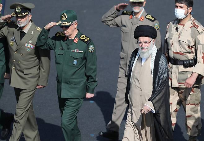이란의 최고지도자인 아야톨라 알리 하메이니가 3일(현지시각) 수도 테헤란에서 열린 경찰·군사학교 졸업식에 참석해 군 사령관들과 걸어가고 있다. 테헤란/EPA 연합뉴스