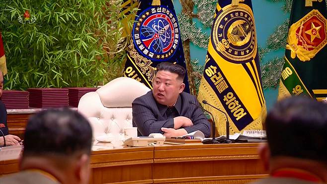 North Korea`s state-run Korean Central Television on Tuesday airs video footage of North Korean leader Kim Jong-un presiding over an enlarged meeting of the party`s Central Military Commission at the headquarters of the party`s Central Committee in Pyongyang on Monday. In the video, Kim is seen sitting in front of the flag of the Missile General Bureau.