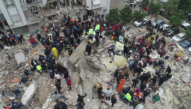 시민들과 안전모를 쓴 구조대가 6일(현지시간) 튀르키예 아다나시의 붕괴된 건물 잔해 위에서 구조작업을 벌이고 있다. 로이터연합뉴스