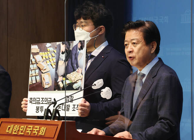 노웅래 민주당 의원(오른쪽)이 2022년 12월14일 국회 소통관에서 기자회견을 열고 "검찰이 축·조의금 봉투 돈까지 꺼내 돈다발로 조작했다"고 주장하고 있다. ⓒ연합뉴스