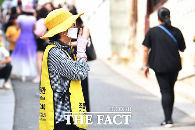 북촌마을지킴이가 마을을 찾은 관광객들에게 정숙해 줄 것을 요청하고 있다.