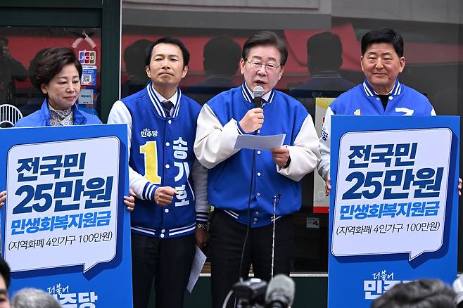 이재명 더불어민주당 대표가 서울 송파구 새마을전통시장에서 가진 총선 유세 과정에서 '국민 1인당 25만원 민생회복 지원금 지급' 정책을 홍보하고 있다. /뉴스1