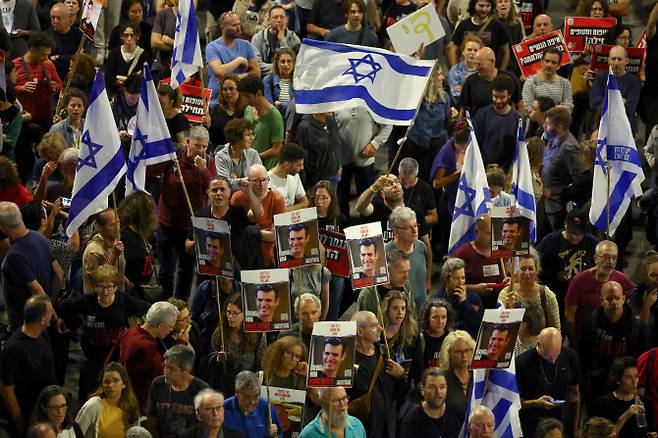 20일(현지시간) 이스라엘 텔아비브에서 사람들이 베냐민 네타냐후 이스라엘 총리를 규탄하고 하마스의 10월 7일 가자지구 이스라엘 공격으로 납치된 인질 석방을 촉구하는 시위에 참여하고 있다. (사진=로이터)