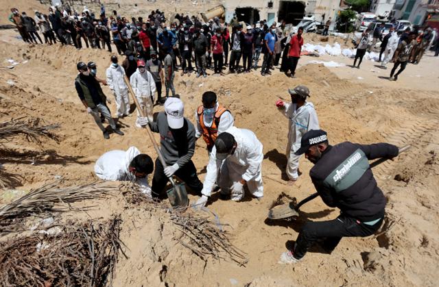 팔레스타인인들이 21일 가자지구 남부 칸유니스의 나세르 의료단지 안뜰에 집단 매장된 시신을 발굴하기 위한 작업을 하고 있다. 22일까지 총 283구의 시신이 발견됐다. 칸유니스=로이터 연합뉴스