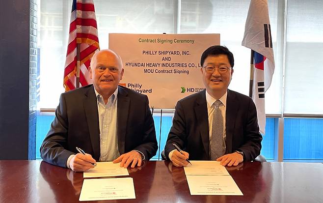Joo Won-ho (right), head of HD Hyundai Heavy Industries' special ship business unit, and Steinar Nerbovik, CEO of Philly Shipyard, sign a memorandum of understanding in Pennsylvania on April 12. (HD Hyundai)