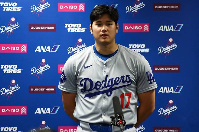MIAMI, FLORIDA - SEPTEMBER 19: Shohei Ohtani #17 of the Los Angeles Dodgers speaks to the media after a game against the Miami Marlins where he became the first MLB player to have at least 50 home runs and 50 stolen bases in the same season at loanDepot park on September 19, 2024 in Miami, Florida. Megan Briggs/Getty Images/AFP (Photo by Megan Briggs / GETTY IMAGES NORTH AMERICA / Getty Images via AFP)