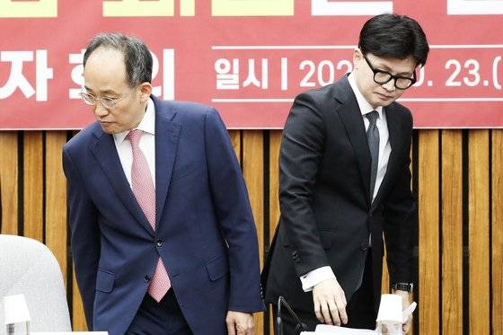한동훈 국민의힘 대표(오른쪽)와 추경호 원내대표가 지난 23일 오전 서울 여의도 국회에서 열린 확대당직자회의에서 기념촬영을 마친 뒤 자리에 앉고 있다. 뉴스1