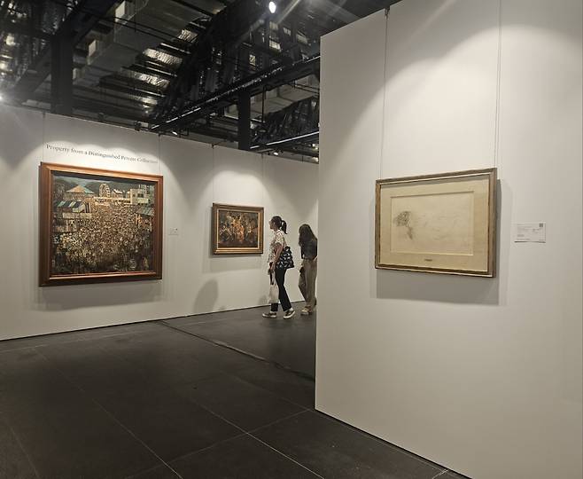 Visitors take a look at artworks at Sotheby's Singapore on Jan. 14. (Park Yuna/The Korea Herald)