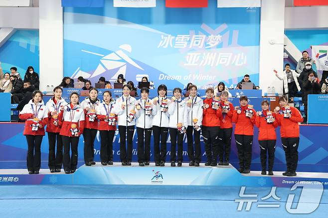 14일 중국 헤이룽장성 하얼빈시 핑팡컬링아레나에서 열린 하얼빈 동계아시안게임 여자 컬링 결승전 한국과 중국의 경기에서 7대2로 승리하며 금메달을 딴 대표팀 선수들이 포디움에 올라 세리머니 하고 있다. 왼쪽부터 김민지, 설예은, 김은지, 김수지, 설예지. 2025.2.14/뉴스1 ⓒ News1 이승배 기자