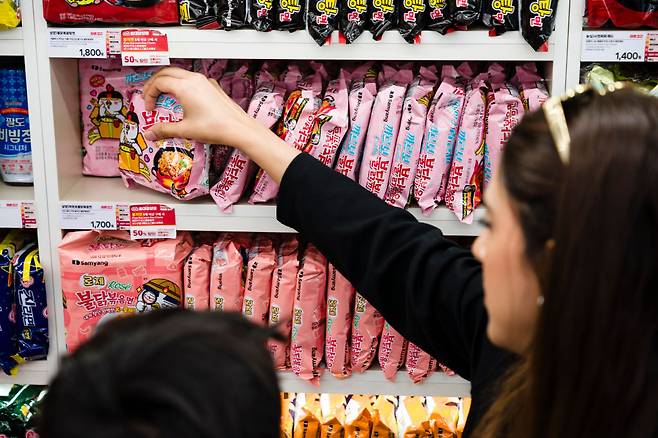 Shoppers browse Buldak noodles at a convenince store in Seoul. (Getty Images)
