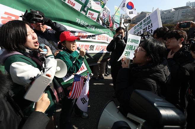 <‘탄핵’이 갈라놓은 대학가> 헌법재판소의 윤석열 대통령 탄핵심판에 대한 결정을 앞두고 대학가에는 탄핵 찬반 집회가 이어지고 있다. 26일 서울 서대문구 이화여자대학교에서 윤 대통령 탄핵 찬성과 반대 집회에 각각 참석한 학생들이 마주보고 구호를 외치고 있다. 한수빈 기자