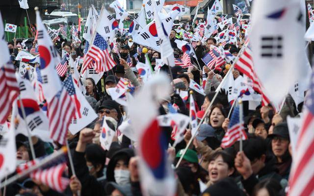 법원의 구속취소 청구 인용으로 석방된 윤석열 대통령이 8일 오후 서울 용산구 한남동 대통령 관저로 들어서자 지지자들이 환호하고 있다. 뉴스1