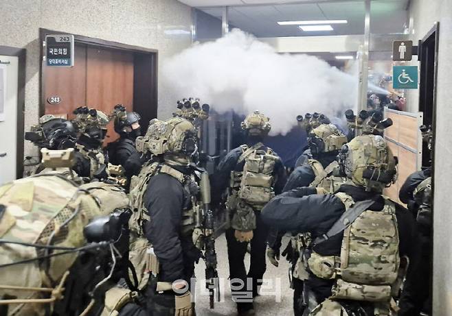 윤석열 대통령이 3일 밤 비상계엄을 선포한 후 4일 밤 서울 국회의사당에서 계엄군이 국회 본청으로 진입했다. 당시 이를 저지하기 위한 보좌진들과 충돌하는 모습. (사진=연합뉴스)