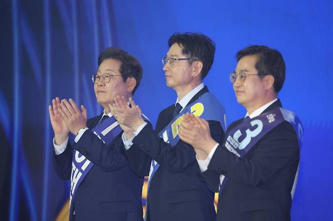 이재명(왼쪽부터), 김경수, 김동연 더불어민주당 대선 경선 후보가 27일 경기 고양시 킨텍스에서 열린 수도권·강원·제주 합동연설회에서 기념촬영을 위해 무대 위에 올라 손뼉치고 있다. /남강호 기자
