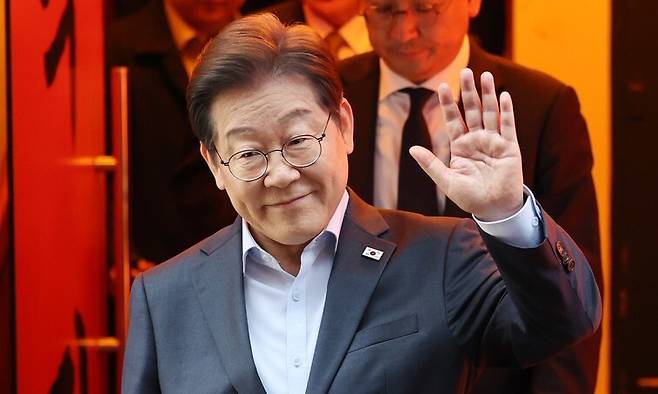 더불어민주당 이재명 대선 후보가 1일 서울 종로구의 한 포차 식당에서 \\\'당신의 하루를 만드는, 보이지 않는 영웅들\\\'이란 주제로 열린 배달 라이더, 택배 기사 등 비(非)전형 노동자들과의 간담회를 마친 뒤 나서며 손인사를 하고 있다. 연합뉴스