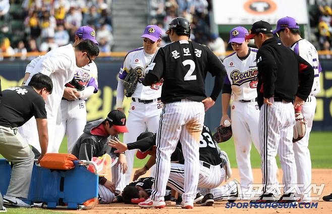 2루를 향해 달리다 충돌 후 쓰러진 오스틴을 걱정하는 양 팀 선수들과 코치진.