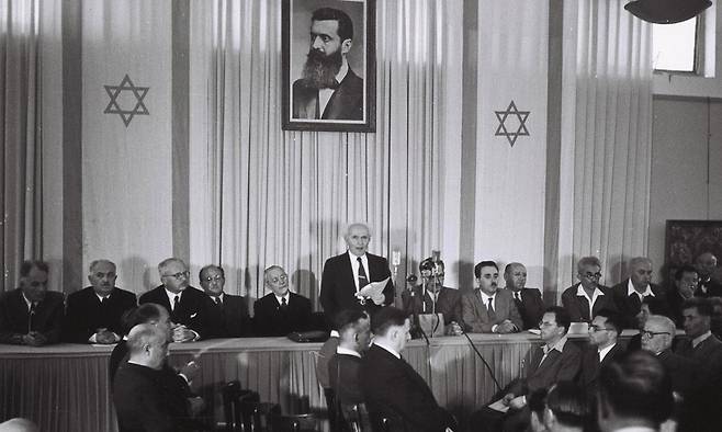 1948년 5월 14일(현지시간) 이스라엘 텔아비브의 미술관에서 유대인 민족위원회의 지도자이자 이스라엘 초대 총리 다비드 벤구리온이 이스라엘 독립선언문을 낭독하고 있다. 텔아비브=로이터