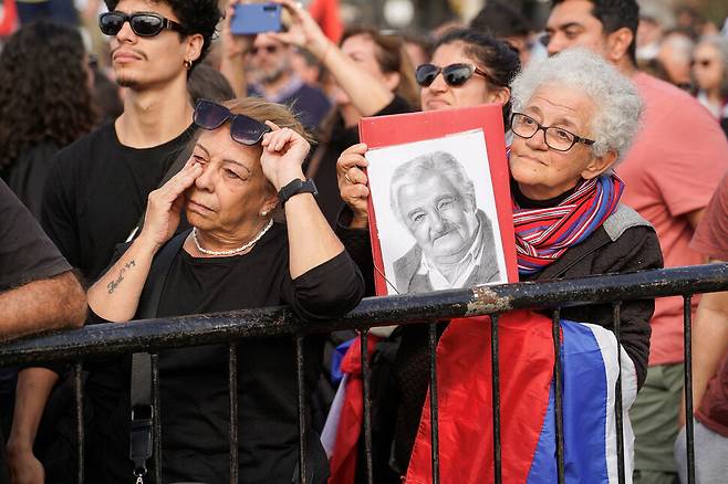 2025년 5월14일 우루과이 수도 몬테비데오의 거리에서 시민들이 호세 무히카 전 대통령의 운구 행렬을 지켜보며 애도하고 있다. REUTERS 연합뉴스