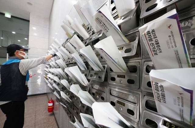 우체국 집배원이 18일 경기도 수원시 한 오피스텔에 제21대 대선 책자형 선거공보물을 우편함에 넣고 있다. 중앙선거관리위원회는 책자형 선거공보는 20일까지, 전단형 선거공보 및 투표안내문은 24일까지 각 가정에 발송한다. 연합뉴스
