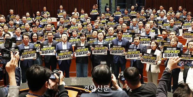 더불어민주당 의원들이 지난 5월 4일 국회에서 열린 긴급 의원총회에서 “사법쿠데타 끝장내자”라고 쓰인 손팻말을 들고 대법원을 규탄하고 있다. 한수빈 기자