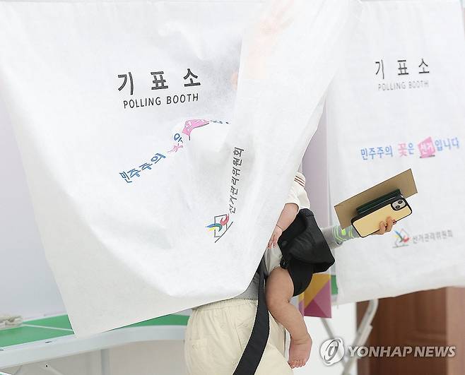 '내 아이를 위해 투표' (대구=연합뉴스) 윤관식 기자 = 제21대 대통령 선거 사전투표 첫날인 29일 대구 달성군 유가읍 행정복지센터에 마련된 사전투표소를 찾은 유권자가 아이와 함께 투표에 참여하고 있다. 2025.5.29 psik@yna.co.kr