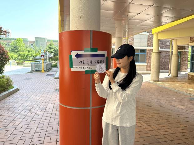 3일 오전 광주 광산구 어룡동 제7투표소가 마련된 선운초등학교에서 생애 첫 투표를 마친 정하진 양이 인증사진을 촬영하고 있다.<정하진씨 제공>