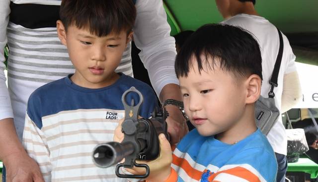 육군이 K-2소총을 차 안에 남겨놓은 채 렌터카를 반납했다 사흘 뒤 민간인의 신고로 회수한 사건이 알려지며 군 내 기강 문제가 대두되고 있다. 사진은 지난 2017년 충남 계룡대에서 열린 계룡 군 문화축제 때 전시된 K-2소총을 만져보고 있는 어린이들. 뉴시스. 사진은 해당 기사와 직접적 관련이 없음