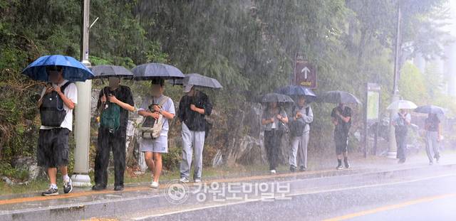 ▲ 강원대 춘천캠퍼스에서 학생들이 우산을 쓰고 강의실로 가고 있다. 방도겸 기자