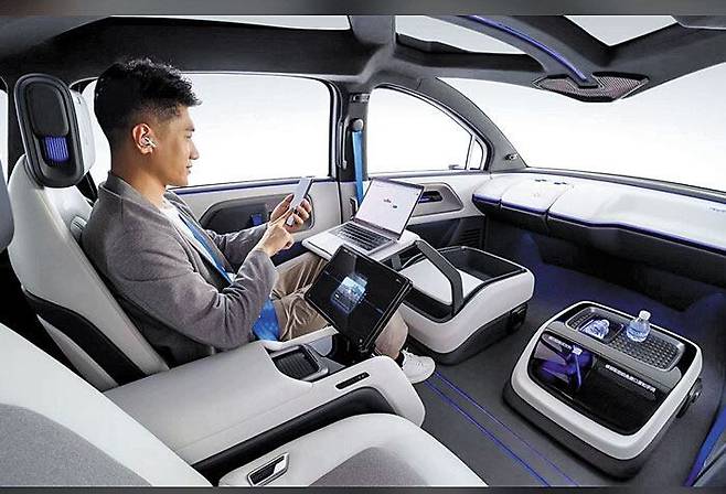 The interior of Baidu’s Apollo RT6 autonomous vehicle, unveiled in May 2024. The car is equipped with Level 4 self-driving technology, which requires no human intervention, and features a removable steering wheel./Baidu