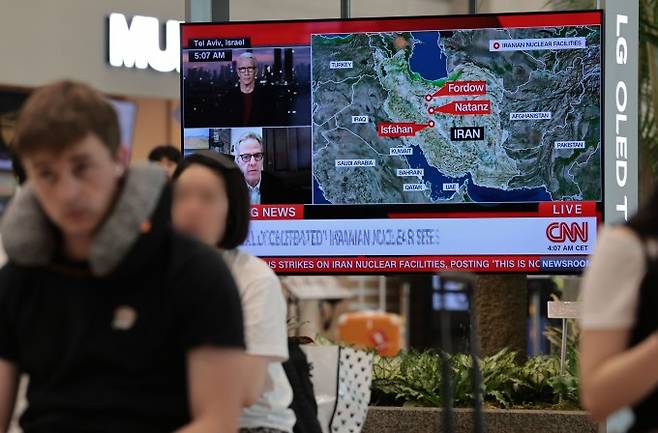 22일 인천국제공항 제1여객터미널 입국장 내 TV에 미국의 이란 핵시설 공습 관련 뉴스가 나오고 있다. 연합뉴스 제공