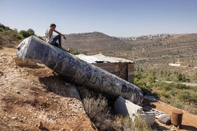 미사일 잔해 위 팔레스타인 청년 : 29일 한 팔레스타인 남성이 요르단 강 서안지구 내에 위치한 네리아 정착촌 인근에 떨어진 이란 미사일 잔해 위에 앉아 있다. 이날 도널드 트럼프 미국 대통령은 이스라엘과 이란 간 휴전으로 ‘아브라함 협정’을 확대할 수 있는 기회가 생겼다고 밝혔다. AFP 연합뉴스