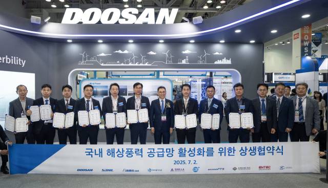 정연인 두산에너빌리티 부회장(가운데)이 2일 부산 벡스코에서 열린 ‘2025 해상풍력 공급망 컨퍼런스’에서 국내 9개 협력사 대표들과 상생협약을 체결하고 기념촬영을 하고 있다. 왼쪽부터 은희성 은성오앤씨 대표, 김호성 성현 대표, 노현호 엘에스케이 상무, 한우진 우림피티에스 부사장, 윤성용 삼일씨엔에스 대표, 양승운 휴먼컴퍼지트 대표, 정 부회장, 손승우 두산에너빌리티 파워서비스BG장, 최동현 산일전기 전무, 김종우 인텍전기전자 부사장, 윤요한 두산에너빌리티 파워서비스영업총괄, 신동규 두산에너빌리티 풍력설계 담당, 한명훈 두산에너빌리티 풍력영업 담당.