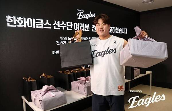 10일 한화그룹의 김승연 회장이 프로야구 정규시즌 전반기 1위를 확정한 한화이글스 선수단과 임직원들에게 특별 격려품을 전달했다고 밝혔다.(한화이글스 류현진 선수가 김승연 한화 회장이 선물한 특별 격려품을 들고 기념 촬영을 하고 있다.).사진=한화 이글스