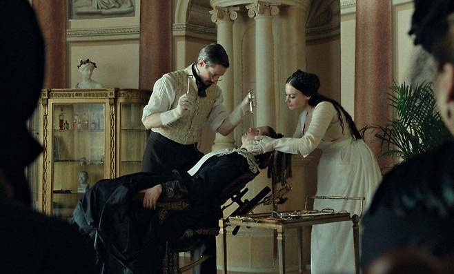 A still from Ugly Sister showing the Cinderella character looking at a shoe.