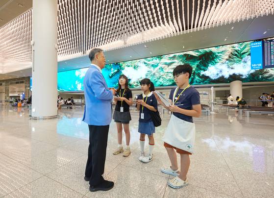 제2여객터미널 3층 출국장에 설치된 거대한 미디어 아트는 공항을 찾은 사람들에게 볼거리를 제공한다며 소중 학생기자단에게 설명하는 김형전(왼쪽) 해설사.