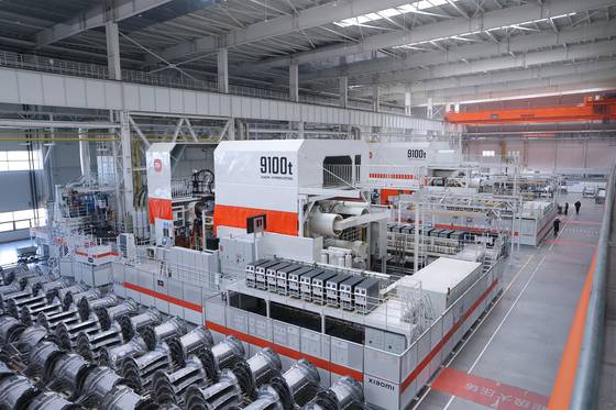 베이징의 샤오미 전기차 수퍼팩토리에서 자체 개발한 T9100 다이캐스팅 기계 옆으로 제작한 차체 부품이 쌓여 있다. 샤오미 제공