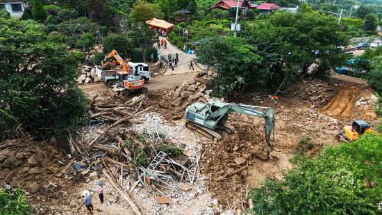 군 및 소방 인력이 중장비를 이용해 호우 피해 복구 작업을 하고 있다.