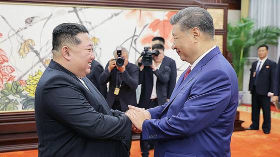 김정은 북한 국무위원장과 시진핑 중국 국가주석이 3일 베이징 인민대회당에서 회담을 진행한 뒤 웃으면서 악수를 하고 있다. 노동신문=뉴스1