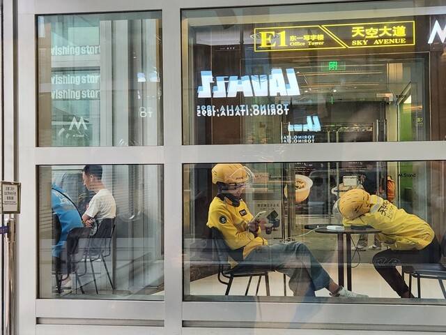 베이징 중심가 왕푸징의 쇼핑몰에서 음식 배달 노동자들이 휴대전화를 충전하며 잠시 쉬고 있다. 베이징/박민희 선임기자 minggu@hani.co.kr