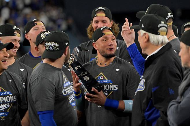 다저스 미구엘 로하스가 지난 18일(한국시각) 월드시리즈 진출이 확정된 뒤 NL 우승 세리머니에서 트로피를 들고 있다. Imagn Images연합뉴스