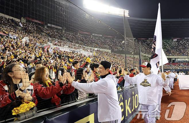 1일 서울 송파구 잠실야구장에서 열린 프로야구 2025 한국시리즈 우승 세리머니 팬 감사 행사 '더 리턴 오브 챔피언스'(The Return of Champions)'에서 LG트윈스 선수단이 그라운드 행진을 하며 팬들에게 손 맞춤을 하고 있다. 2025.11.1/뉴스1 ⓒ News1 이호윤 기자